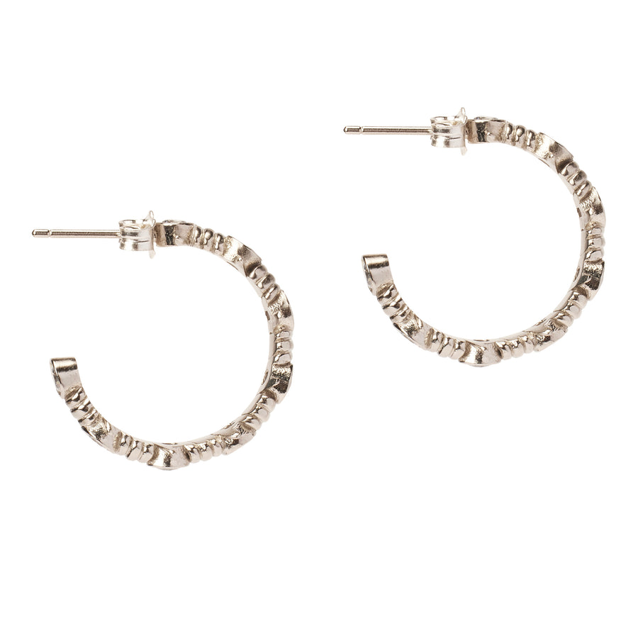 Side view of the Caught Up Earrings by Thorne Dynasty in silver with clear crystal details.