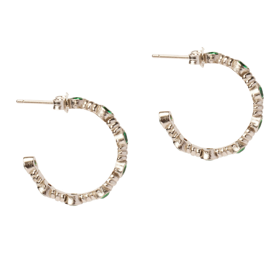Side view of the Caught Up Earrings by Thorne Dynasty in silver with emerald details.