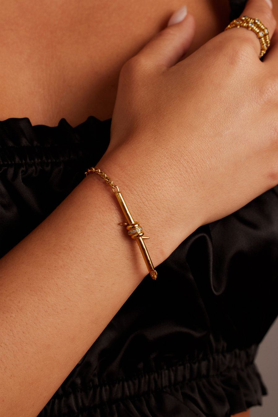 Woman wearing the Last Thorne Bracelet from Thorne Dynasty in gold.
