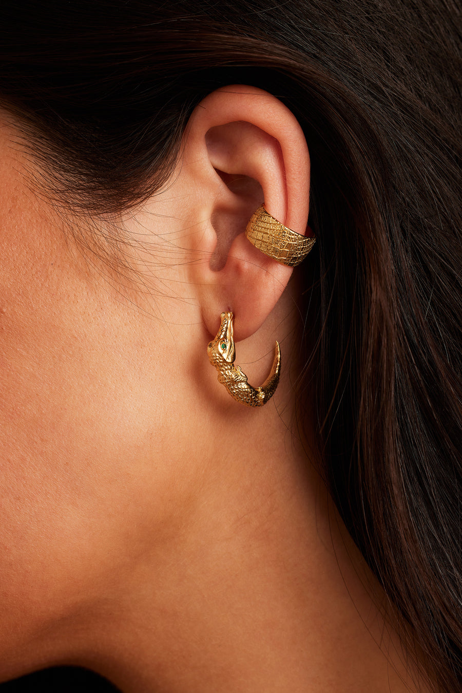 Woman wearing the Zapata Eye Croc Earrings in gold paired with the Desert Darling Ear Cuff