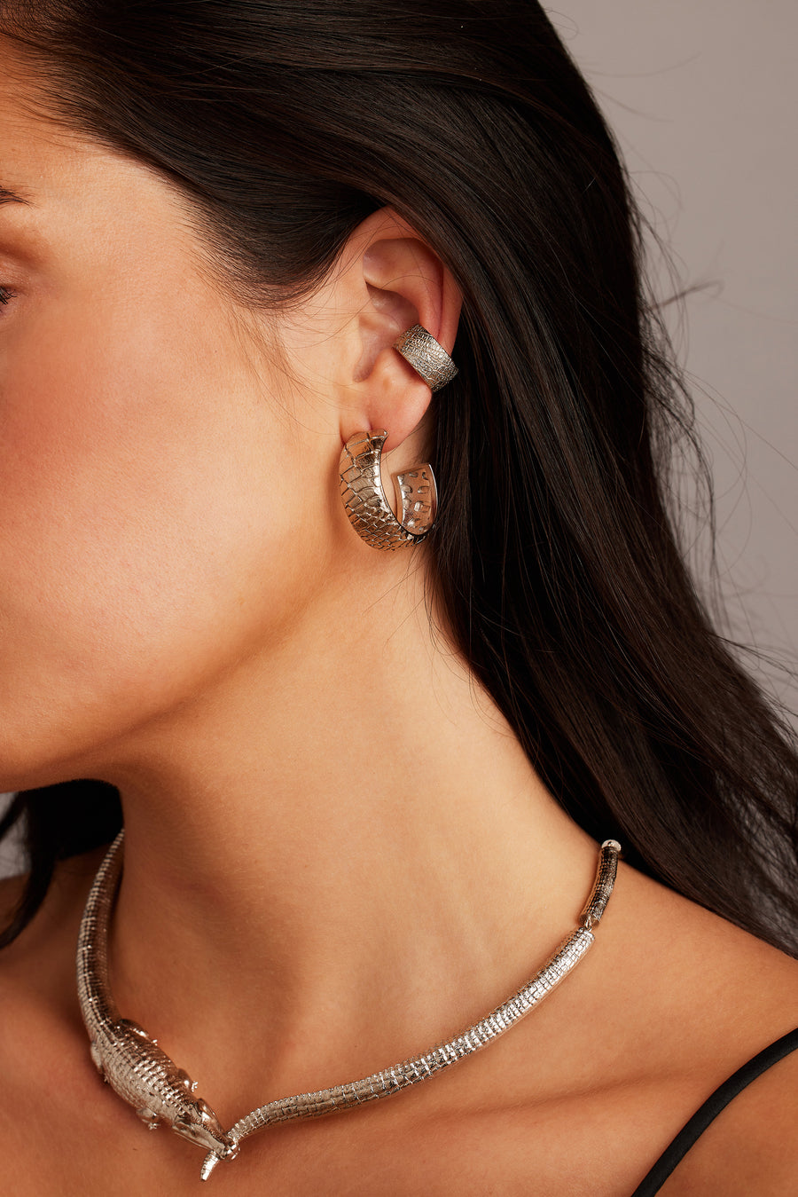Woman wearing the Desert Darling Earrings in silver, paired with the Croc Kingdom Collar and Desert Darling Ear Cuff